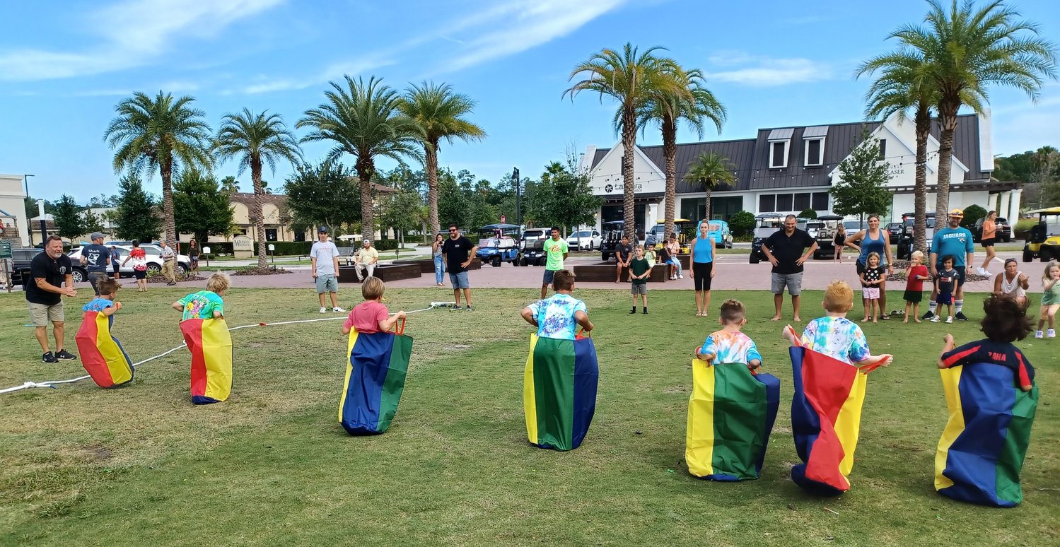 Kids compete in a potato sack race during the Family Olympics recently at the link. The fun competition was conducted in conjunction with the Business Expo at the unique facility in Nocatee. The occasion was the first anniversary of the link.
